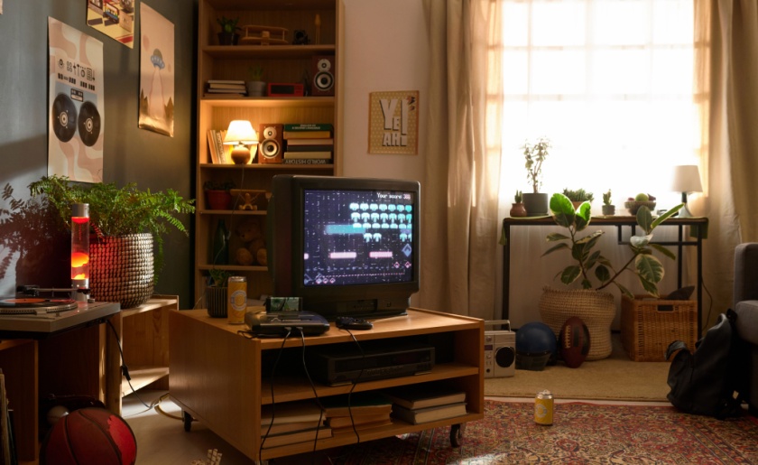 Retro gaming setup with old-fashioned TV, and gaming console.