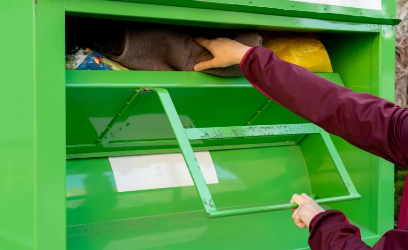 Dropping clothes off in recycling bin