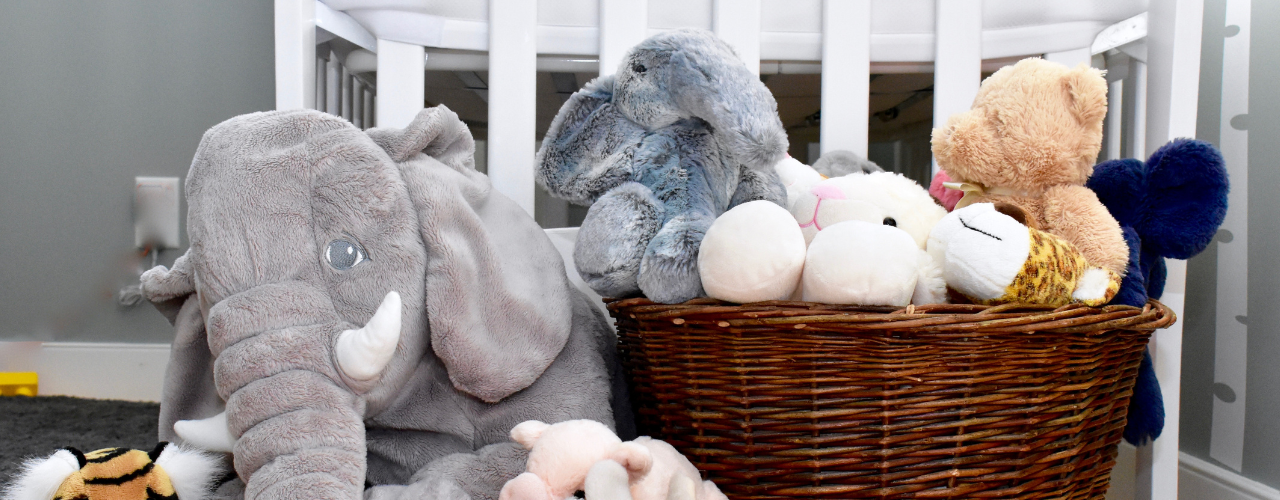 Bedroom with basket of stuffed toys.