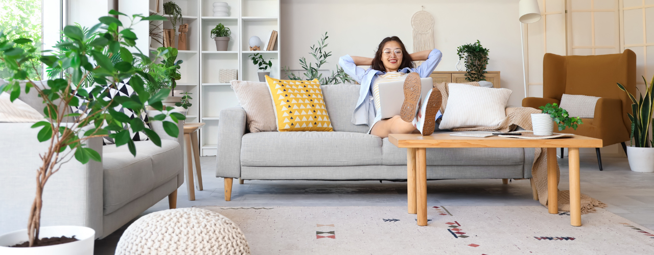 Relaxing at home with feet on the coffee table. Uncluttered, sun-filled home.