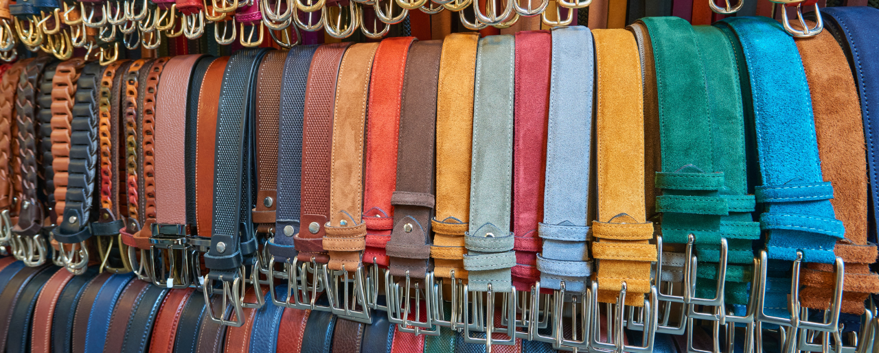 Multi-colored belts stored vertically on a rack. Belt storage and display.