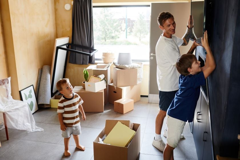 Family mounting TV on wall