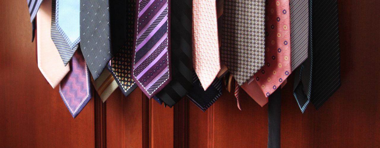 Ties hanging in a closet. Vertical storage for neckties