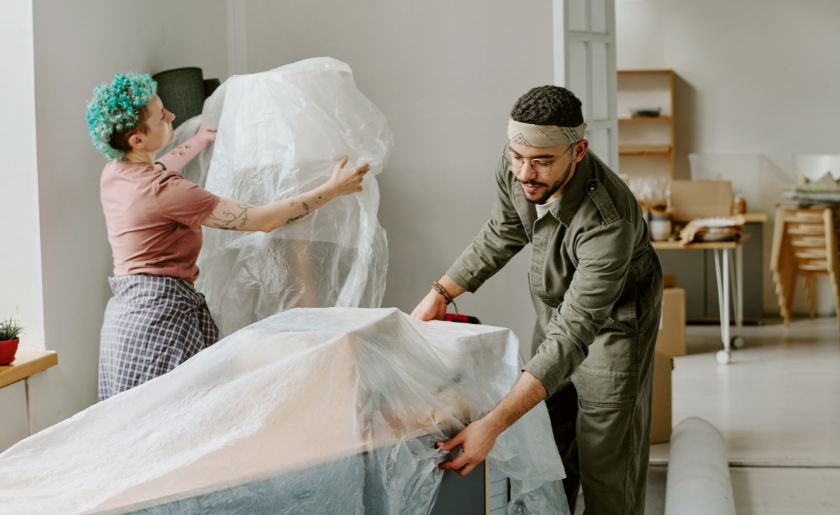 Woman and man packing furniture for donation.