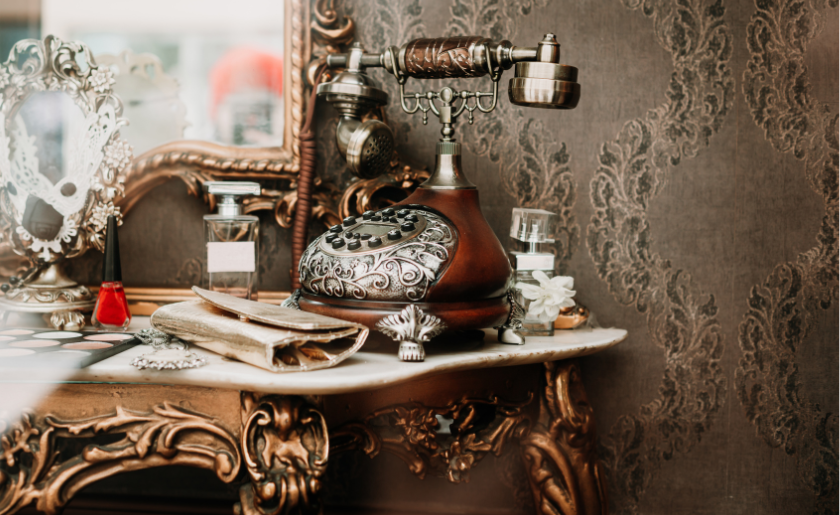 Vintage silver telephone on maximalist table.