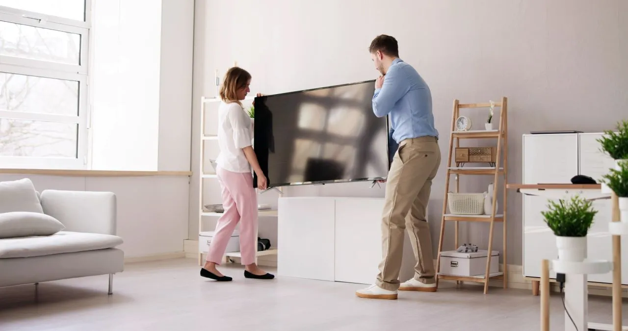 Couple moving their TV