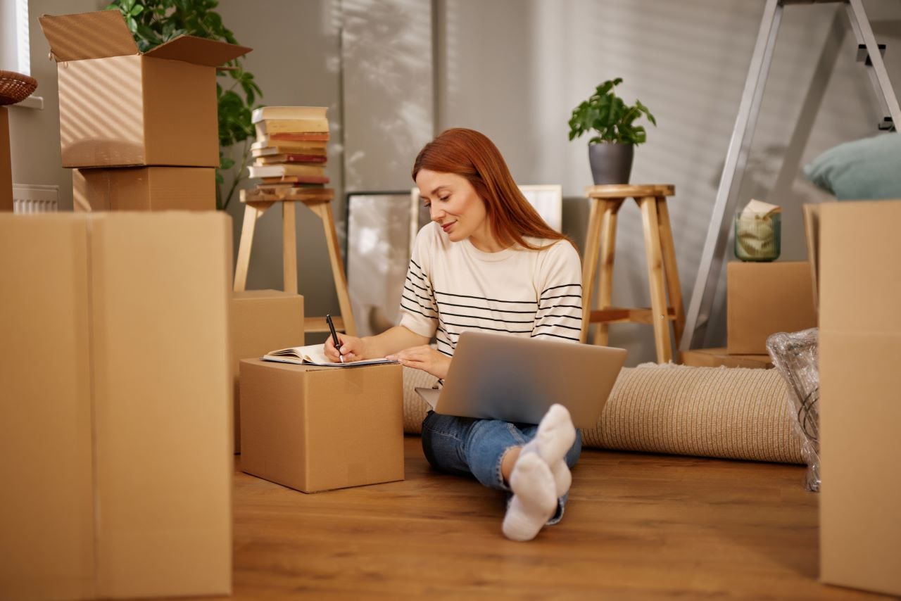 Woman on the floor moving into new apartment