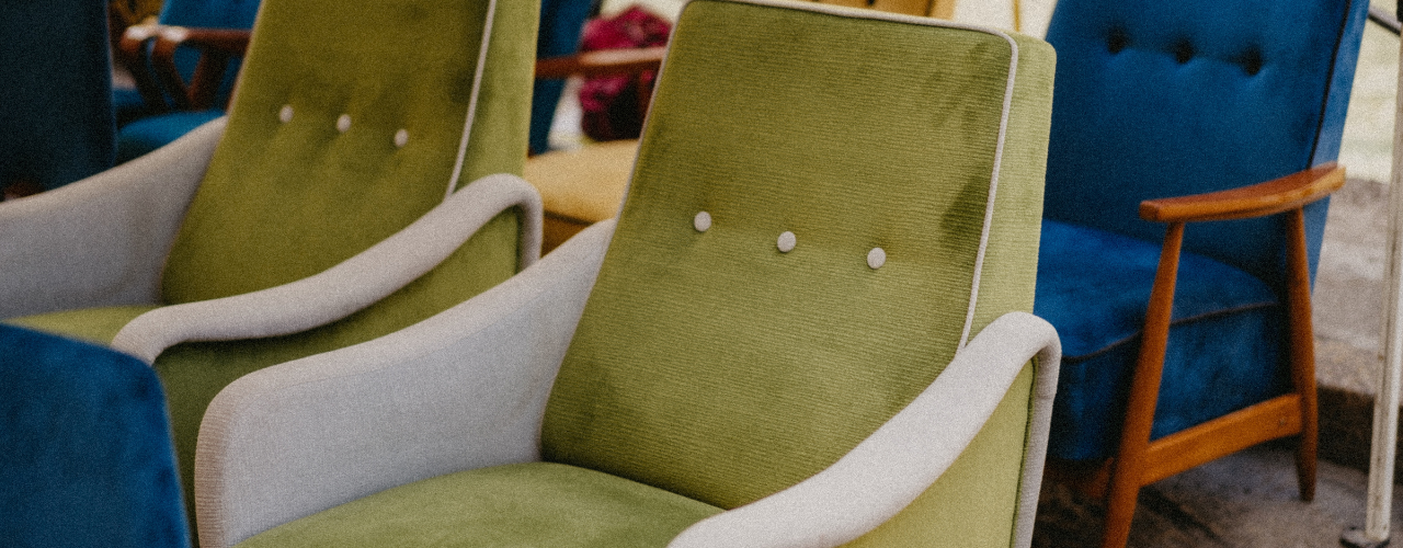 Mid-century vintage armchairs displayed outdoors at a flea market