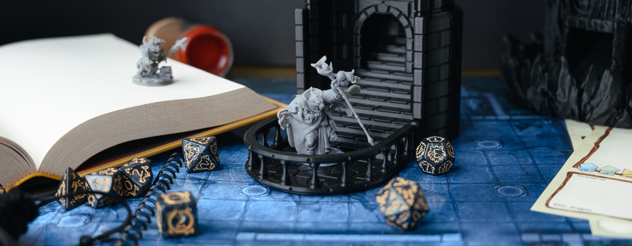 Top-down view of a tabletop RPG setup with dice, miniatures, character sheets, a dice tower, and a fantasy map.