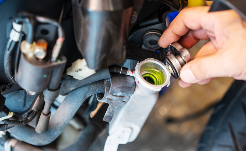 Man pouring new oil into the motorcycle engine.
