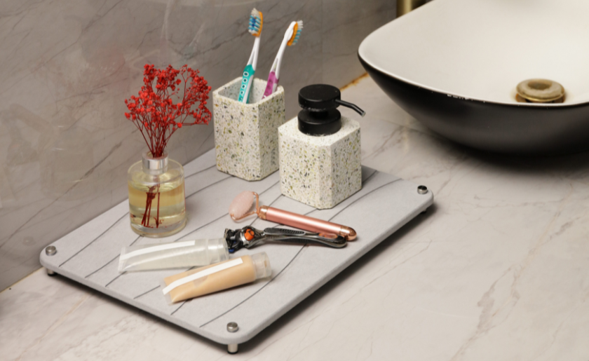 small tray with skincare and cosmetic products near bath sink