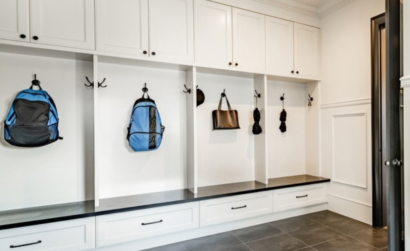 Elegant, white, compartmentalized mudroom