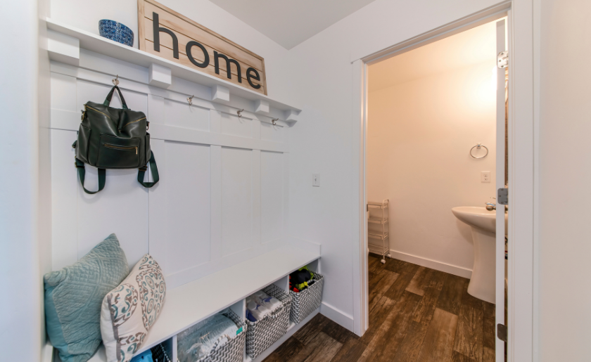 Mudroom interior with a view of a sink on the other room