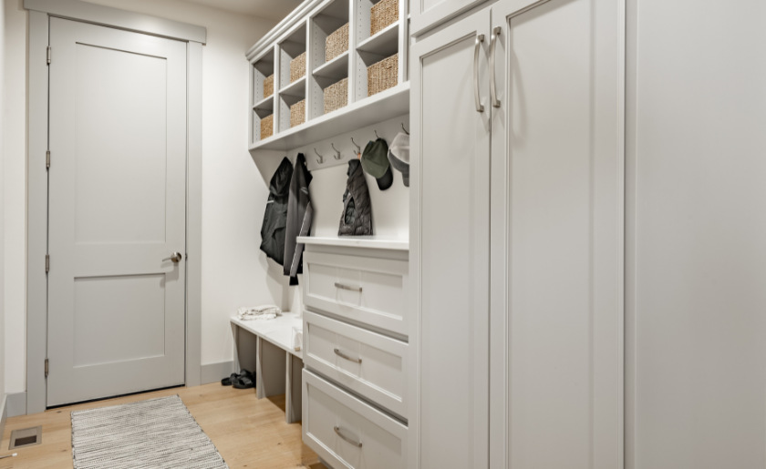 Mudroom with wrought iron railings leading into a modern farmhouse style family home