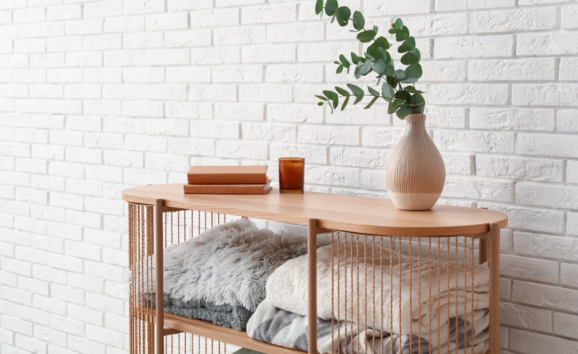 Stylish wooden shelving unit for blanket storage in the living room