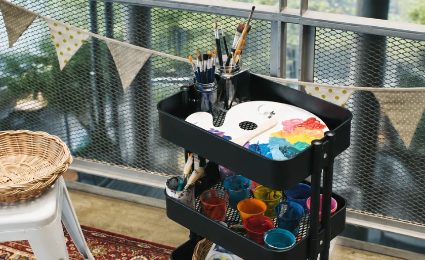 Rolling cart with art supplies.