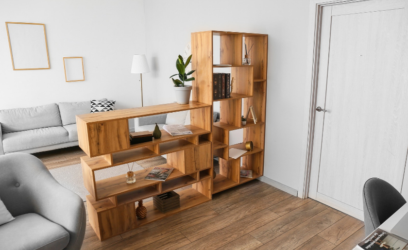 Wooden bookcase as a divider in a living room